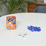 Left Center Right, Tin showing game components including a tin, dice, and blue markers on a table.