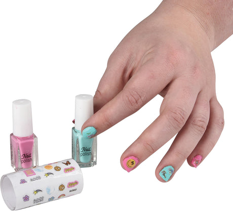 Hand with painted nails near nail polish bottles and a tube of stickers on a white background