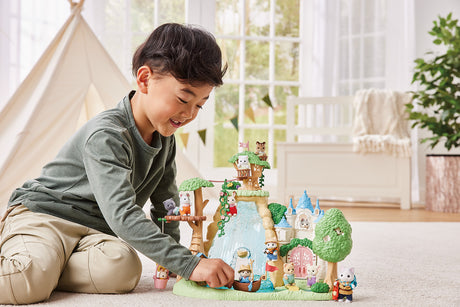 Child playing with a toy Calico Critters Secret Forest Falls set in a bright room