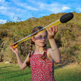 Girl holding a Bad Rap Javelin outdoors with greenery in the background