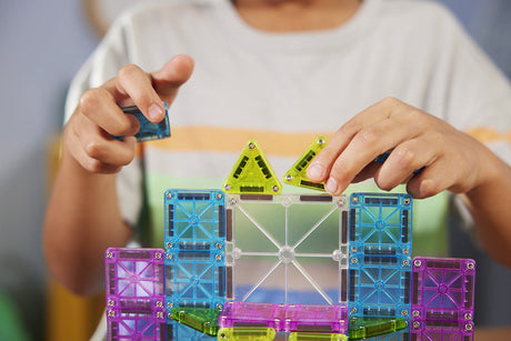 Child playing with colorful magnetic building blocks