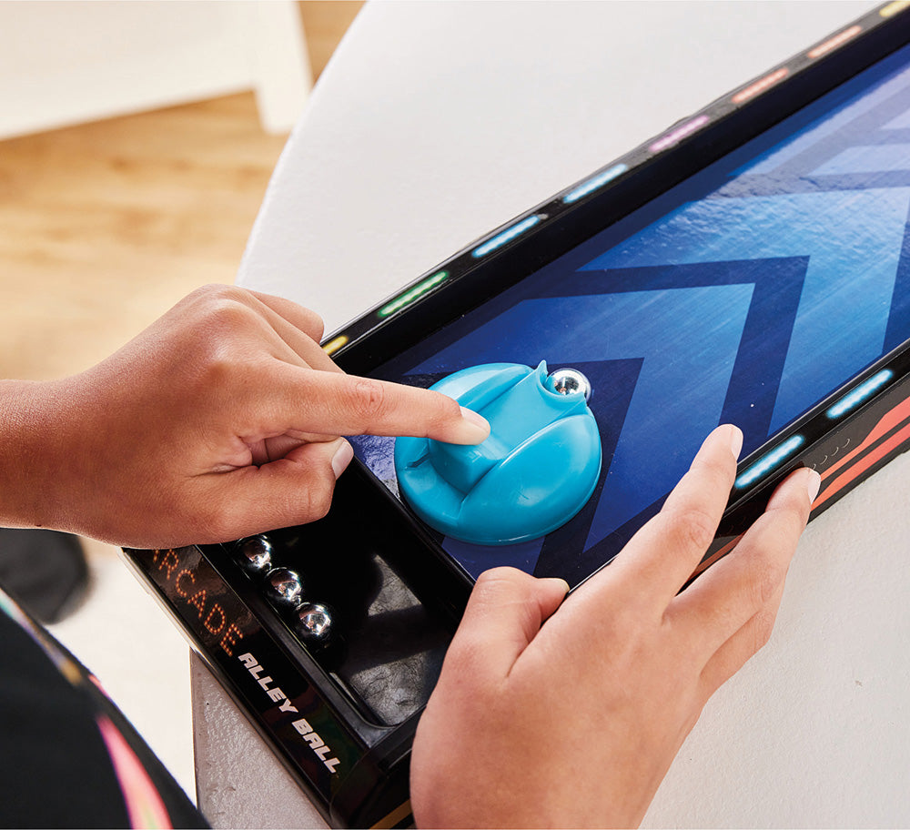 Person playing Arcade Alley Ball game on a tablet with a blue joystick.
