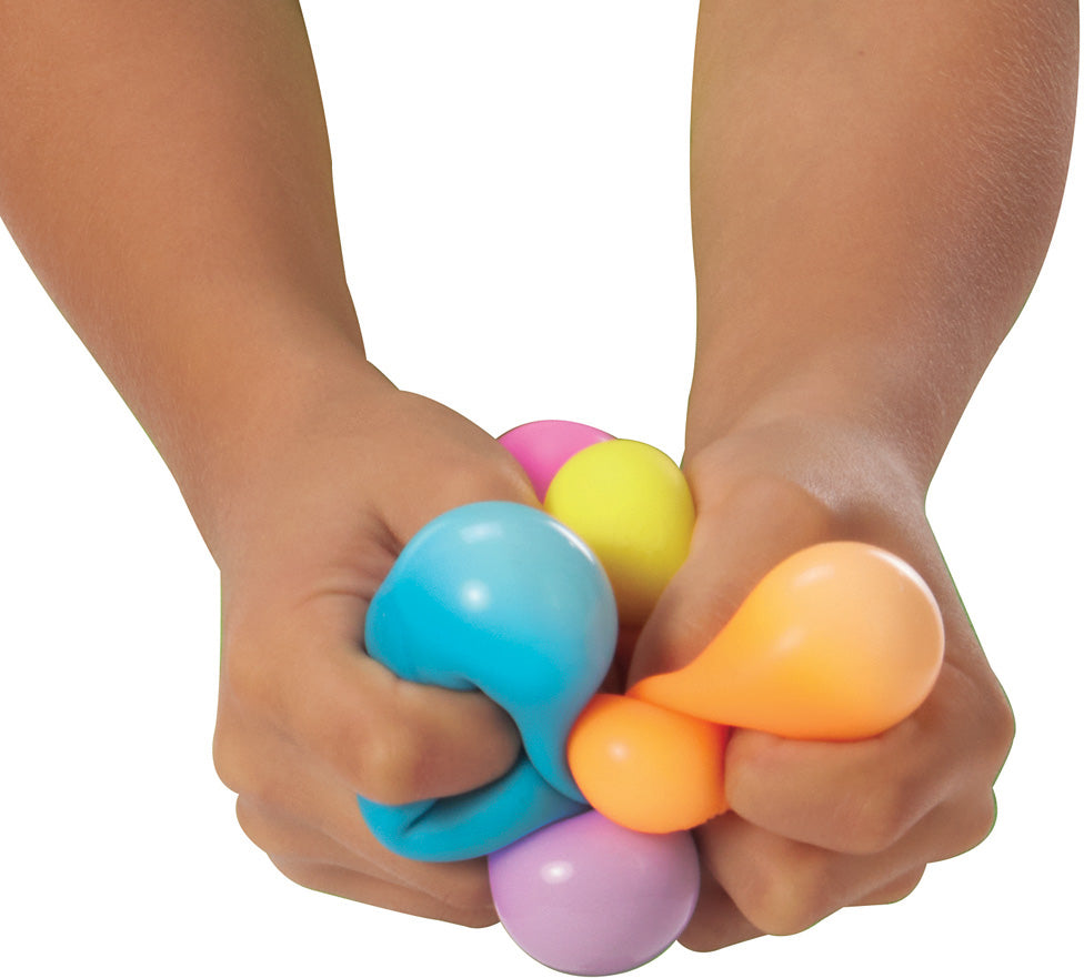 Colorful Teenie NeeDoh Rainboh being squeezed by hands on a white background