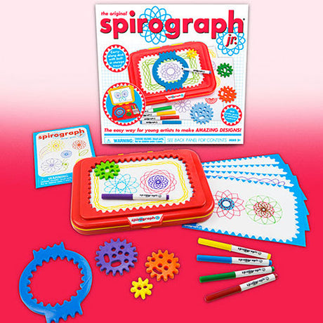 Spirograph Jr. drawing set with gears, markers, and design paper on a pink background