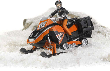 Model of a snowmobile with a rider on a snowy background