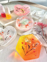 Colorful soap bars with dried flowers on a white surface