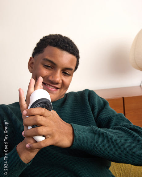 Young boy holding a Oreo Squishi Toy with a neutral background