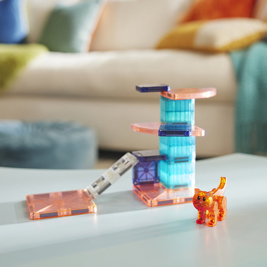 Magna-Tiles Cat Tree 13 Piece Set with a small figurine on a light surface, blurred sofa in the background
