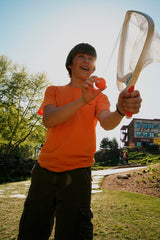 Person holding a Djubi SlingBall Classic outdoors