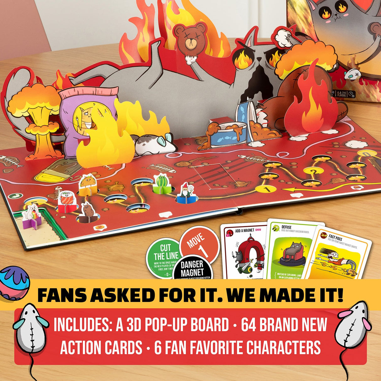 Exploding Kittens The Board Game with 3D pop-up board and action cards on a wooden surface.