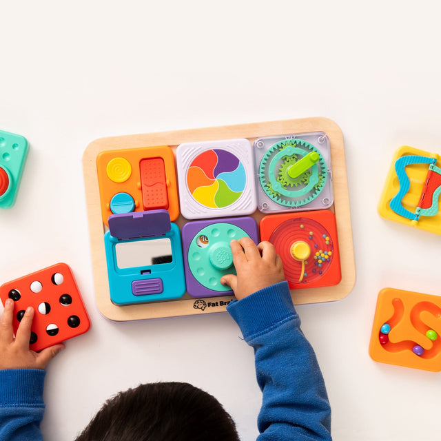 Child playing with a PlayTab - Modular, Sensory, Activity Board on a white surface