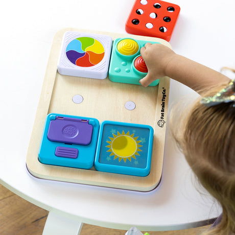 Child playing with a PlayTab - Modular, Sensory, Activity Board on a white table.
