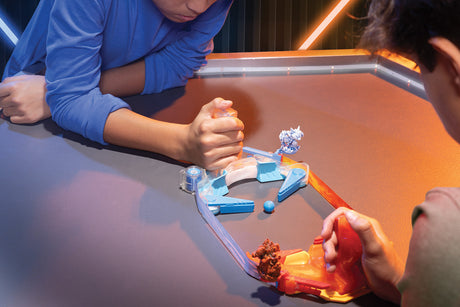 Two children playing with Doteki Multiplayer Battle Pack on a table