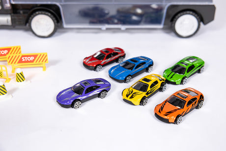 Colorful toy cars on a white surface with a toy truck in the background.