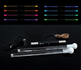 Wandini Glow.0 Magic LED Levitation Wand Light-up sticks with colorful lights and a power cable on a black background