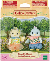 Calico Critters Citrus Bird Family featuring two small bird figurines dressed in colorful citrus-themed outfits standing in a garden setting with trees and flowers, suitable for children aged 3 and up.