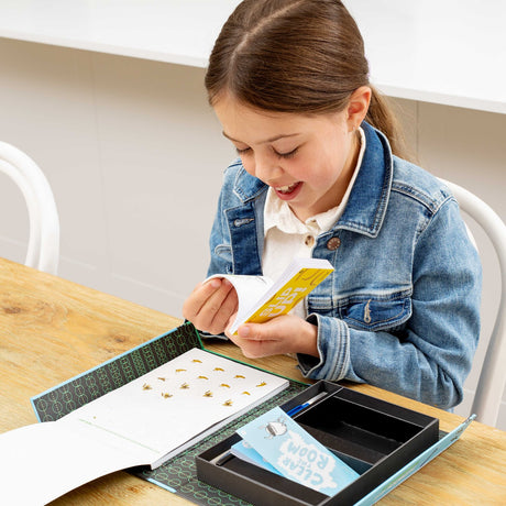 Young girl in a denim jacket interacting with a Flip Book Kit - Animation In Action on a table.