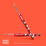 Red crochet hooks with Hello Kitty design on an orange background