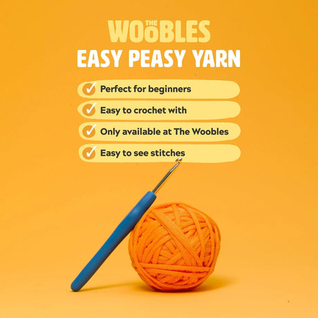Orange ball of yarn with a blue crochet hook on an orange background, featuring text about 'The Woobles Easy Peasy Yarn'.