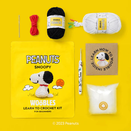 Peanuts Snoopy Wobbles learn to crochet kit on a yellow background