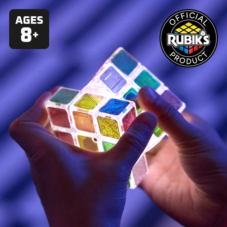 The Official Rubik's Pulse , Colorful Rubik's product held by hands with 'Official Rubik's Product' logo and age restriction label.